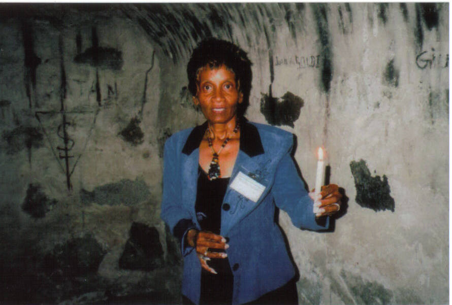 Queen Mother Dorothy Benton Lewis, member of the AFRE delegation, stands in a room within a tunnel that imprisoned captured Africans underneath Hacienda San Jose.